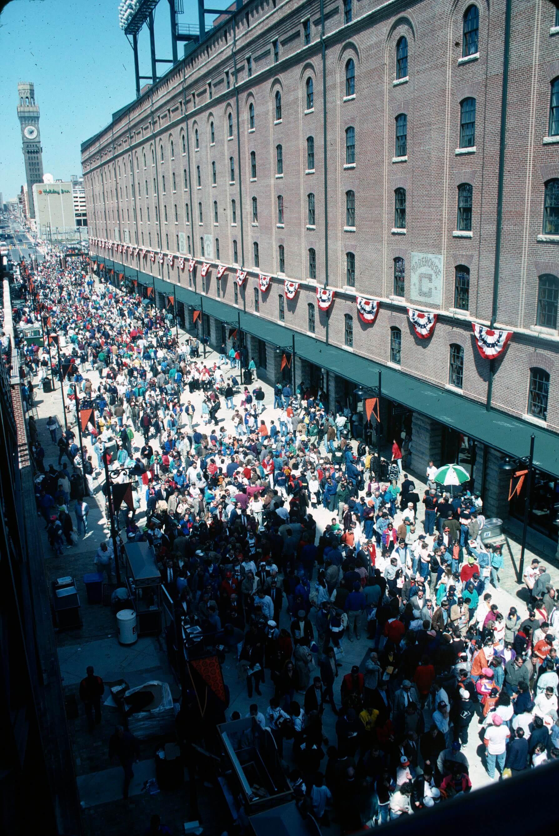 Large crowd of people walking down the street inside Camden Yards