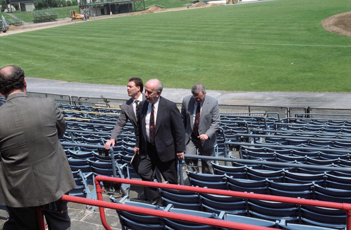Officials walk through the seating area at Memorial Stadium while touring the field after its closure.