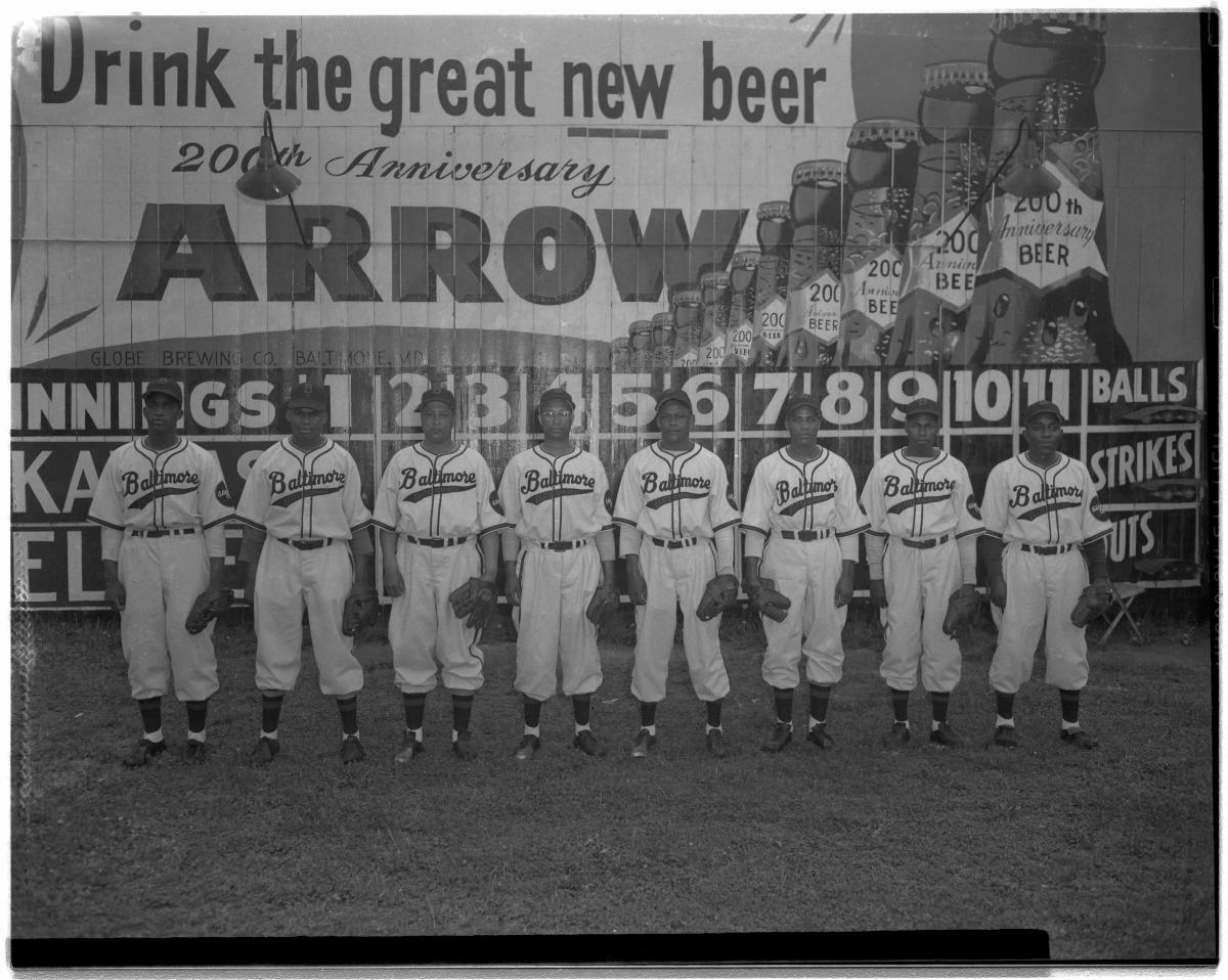 Black and white photo of a team posing in a line for the camera