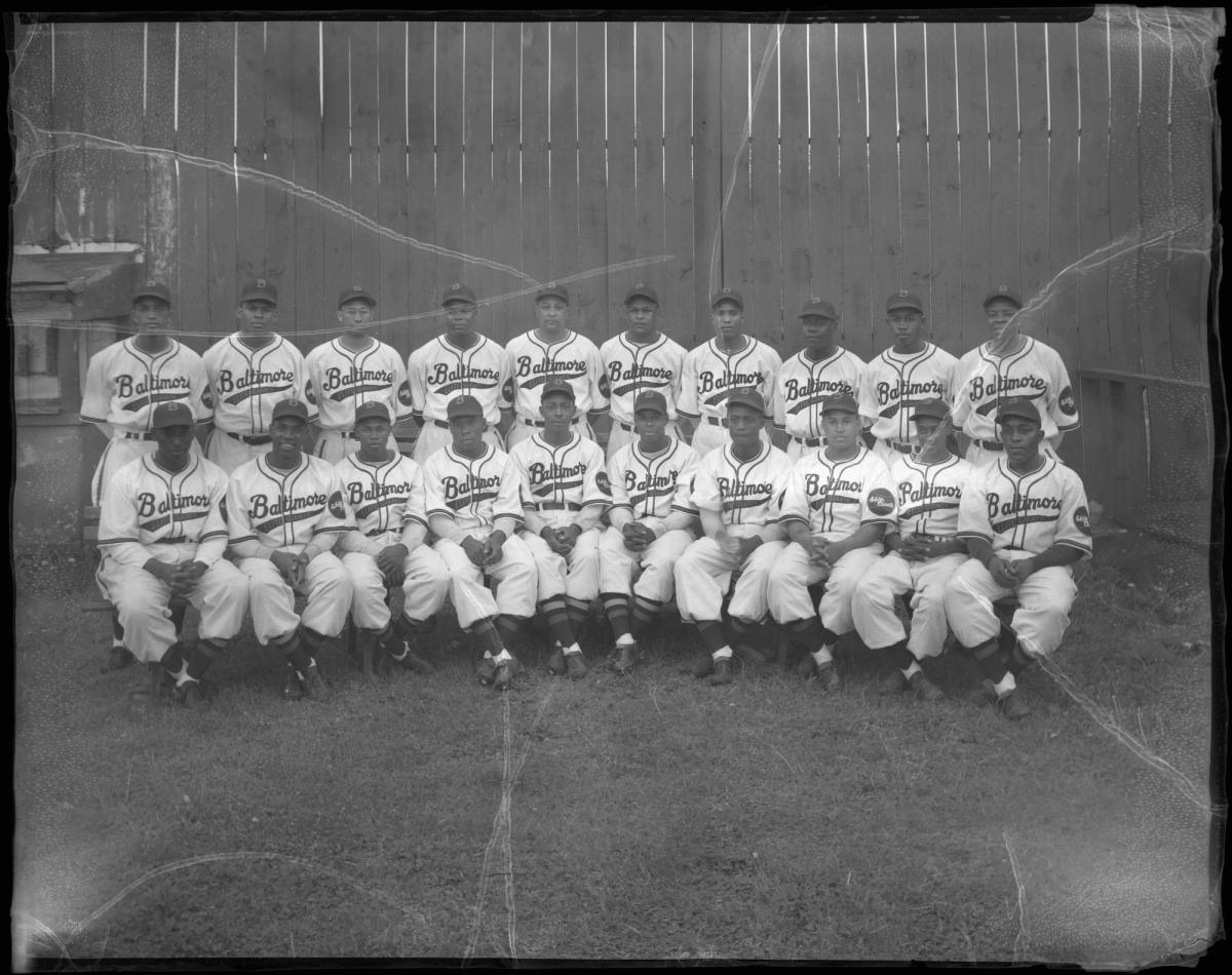 Black and white photo of a team posing in two lines for the camera