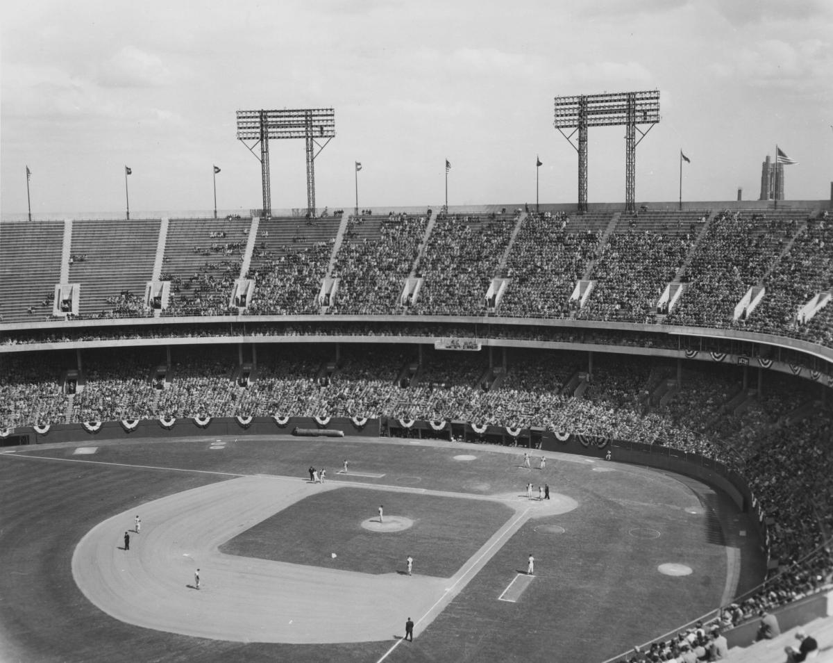 Black and white photo a baseball game in progress inside Memorial Stadium with fans filling the stands.