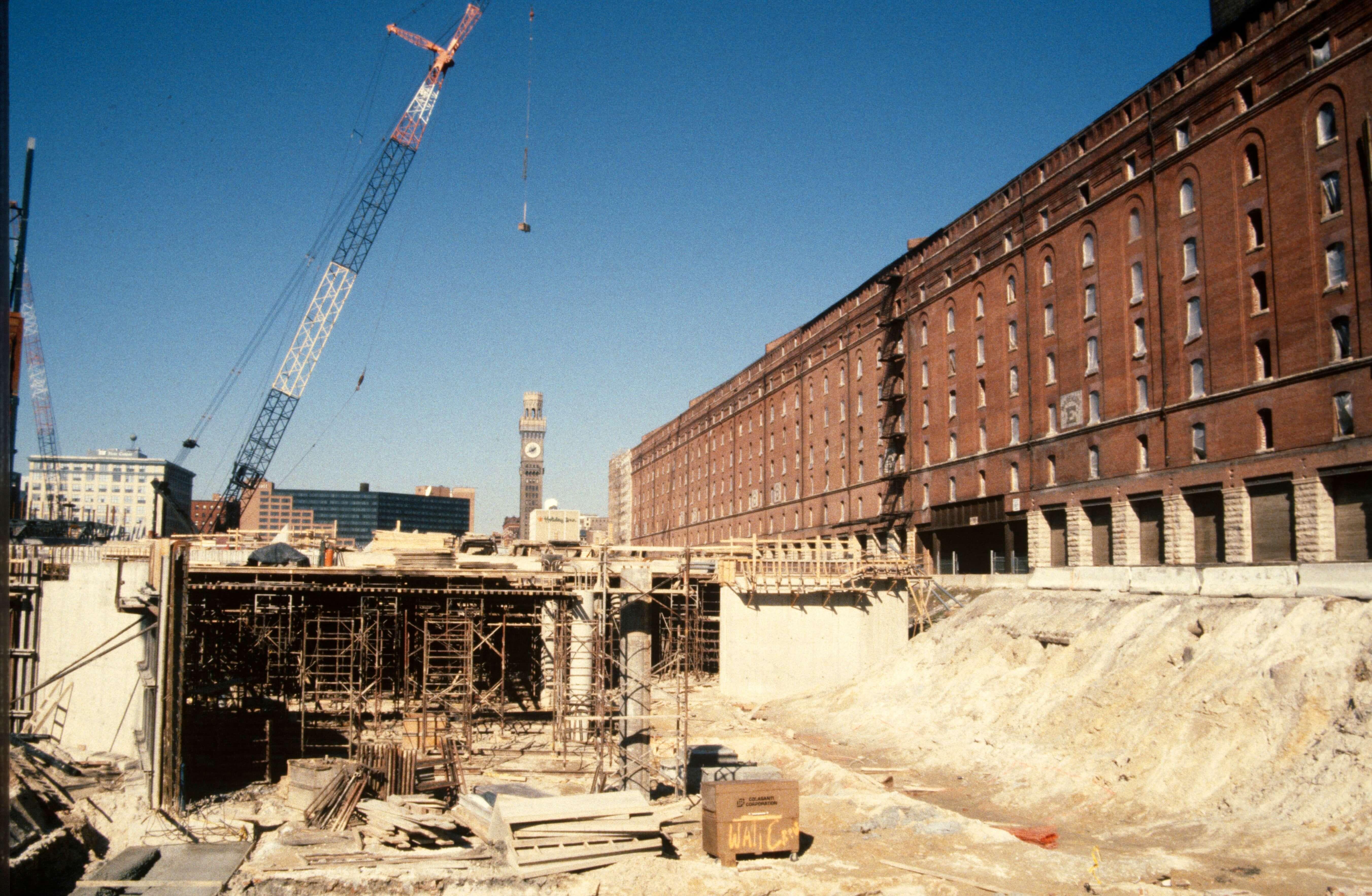 Construction site beside the long brick B&O Warehouse with cranes and scaffolding visible.