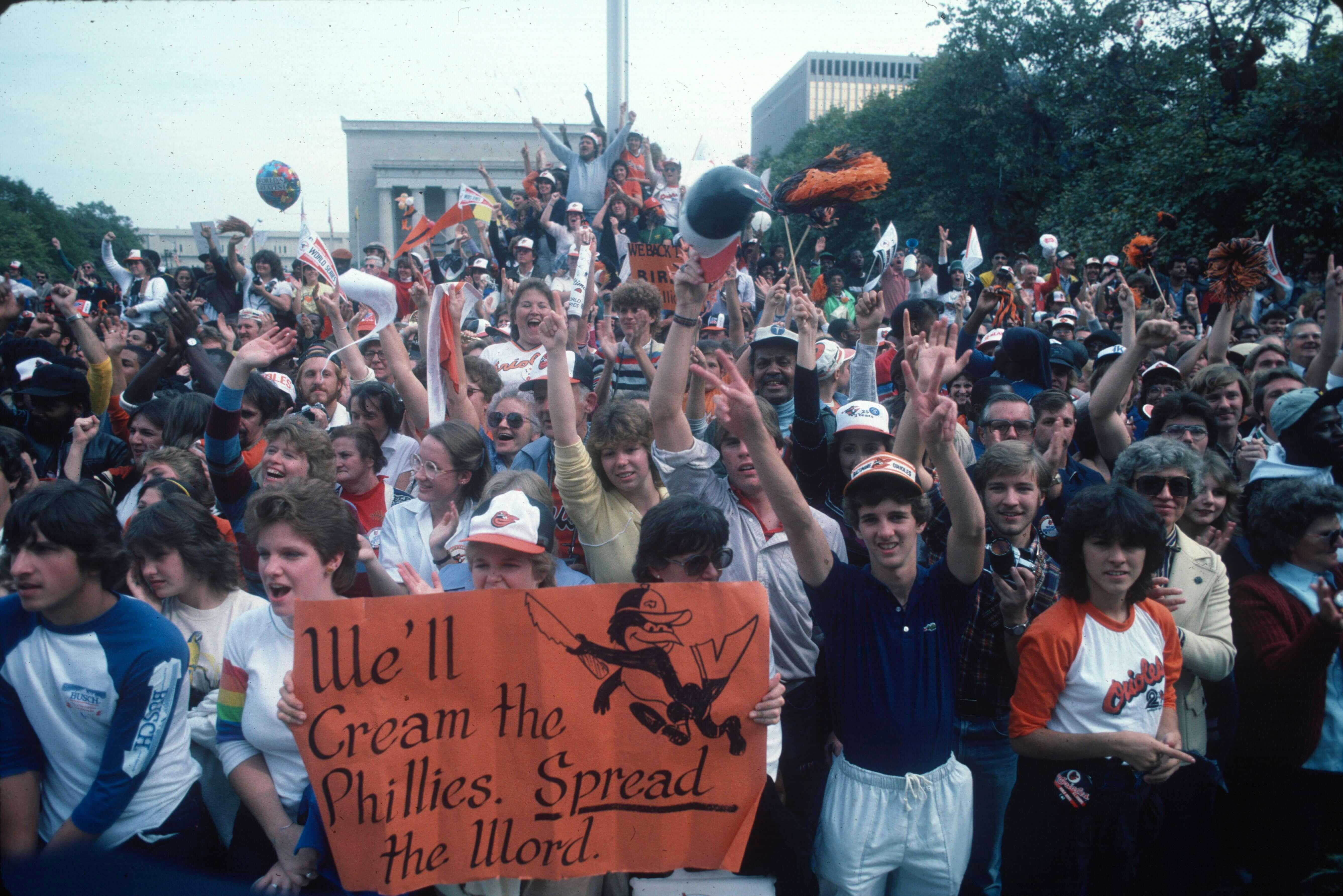 Large crowd of fans celebrating and holding up signs