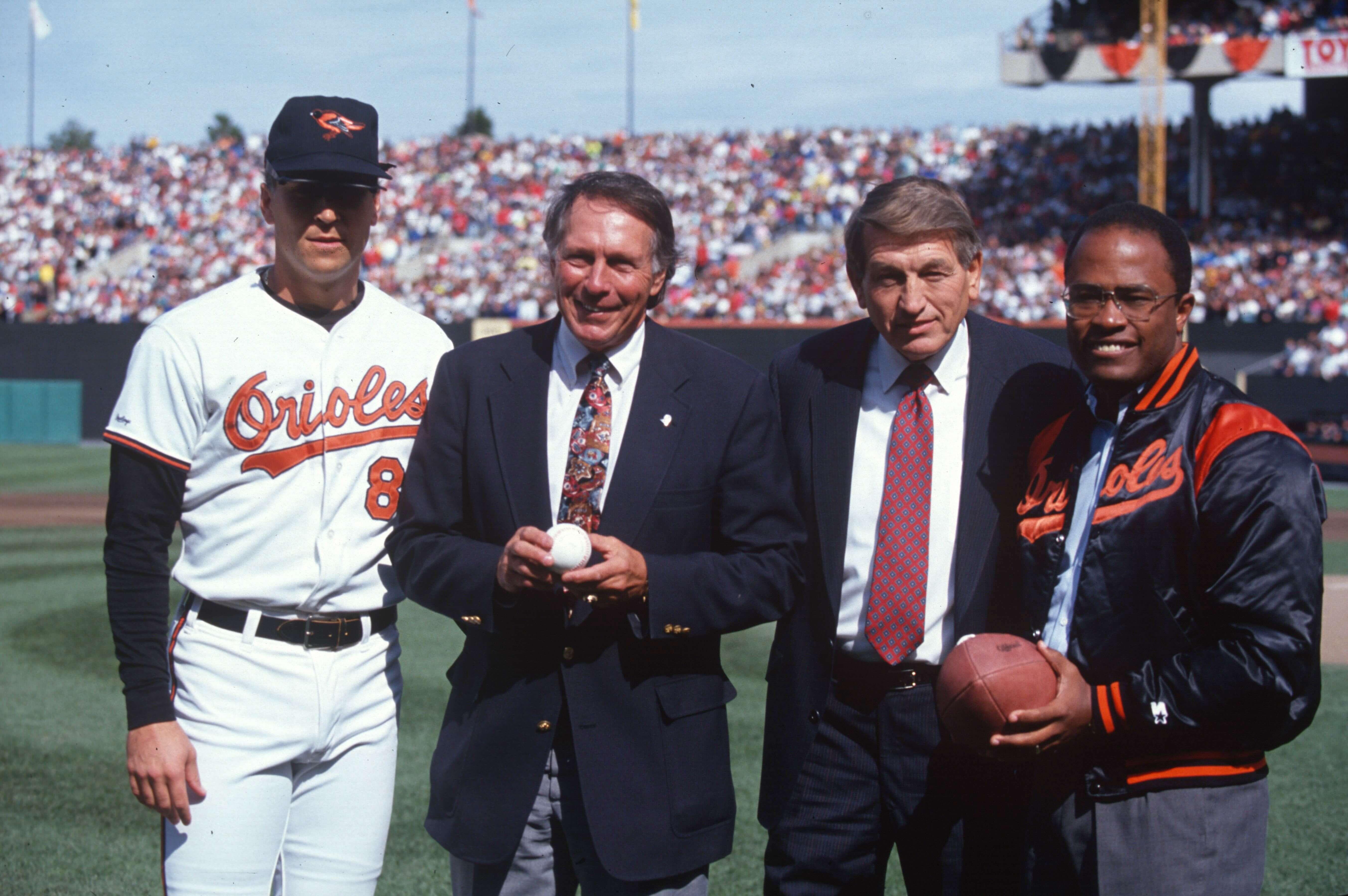 The mayor and guests stand on the field with an Orioles player