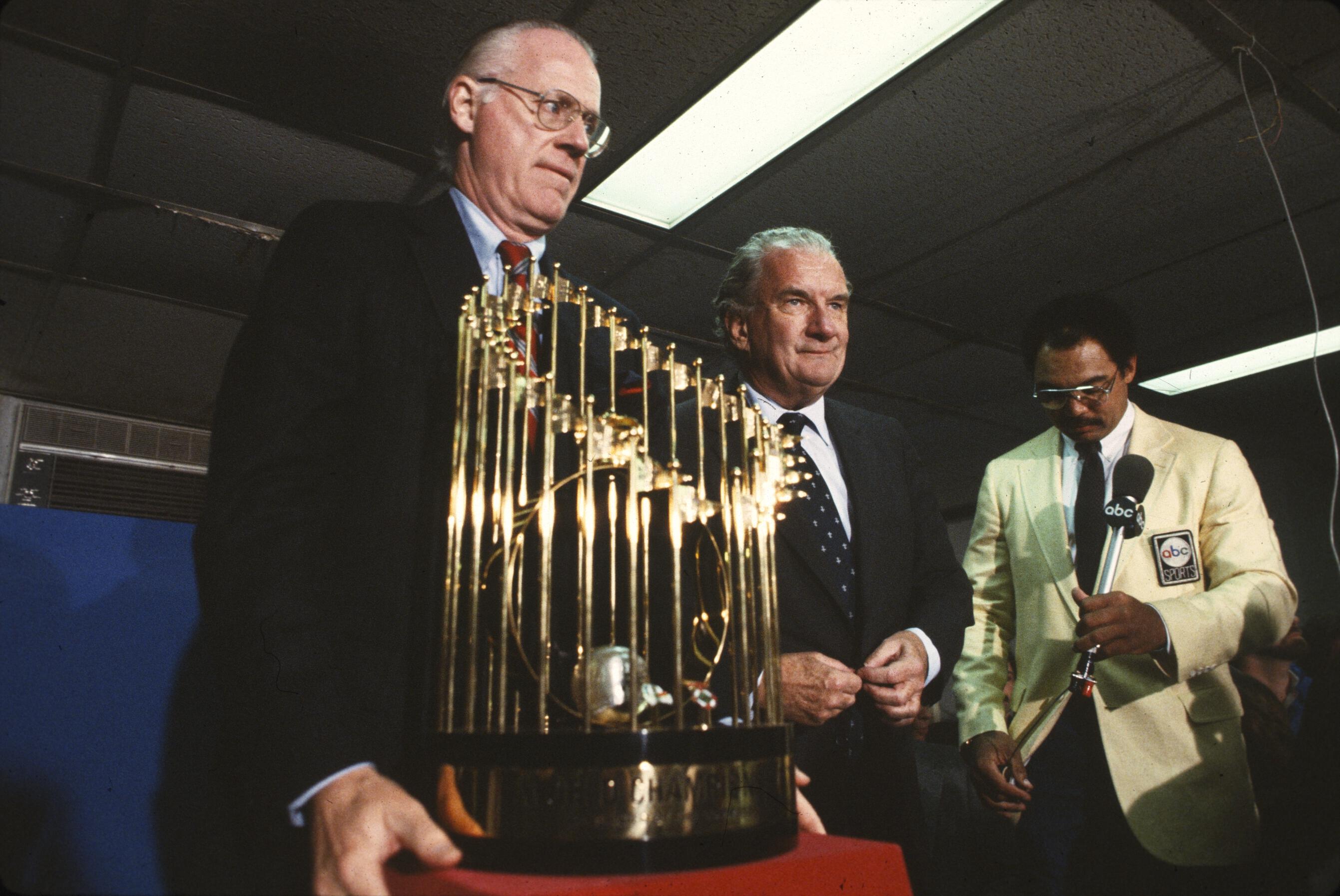 Williams Edward Bennett standing by the World Series trophy