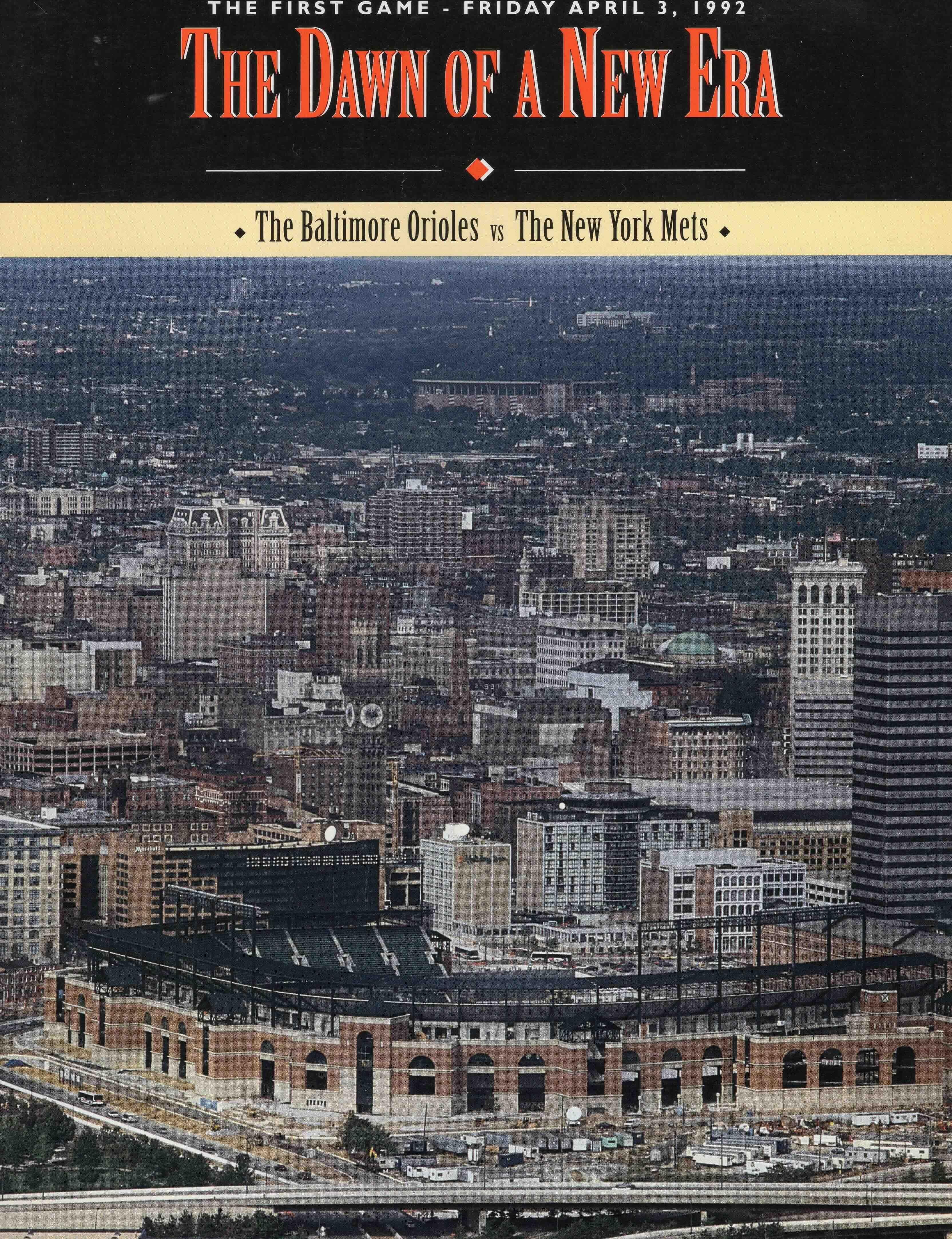 First game program cover that says "The Dawn of a New Era" with an aerial shot of Camden Yards