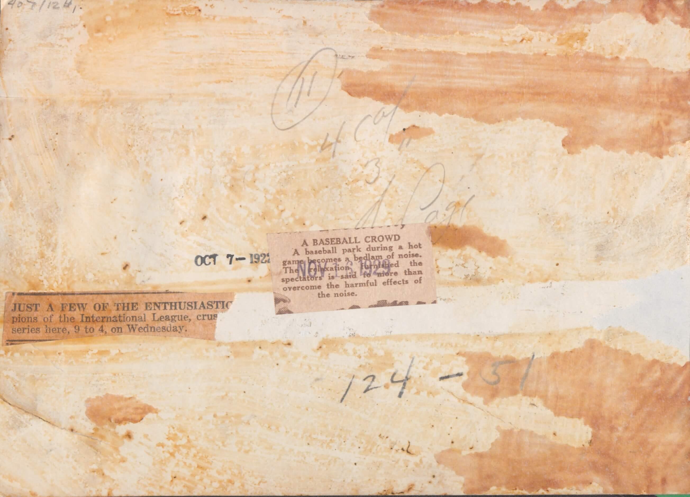 Back of an old photograph with newspaper clippings